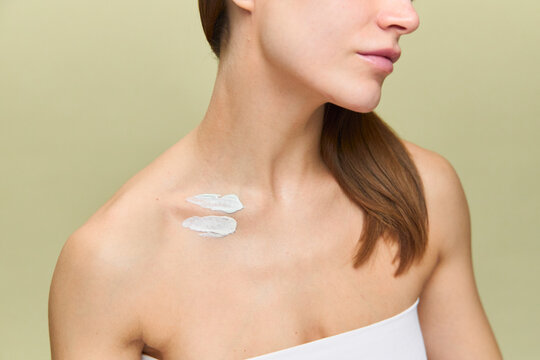 Spots of cosmetic cream on a woman's body