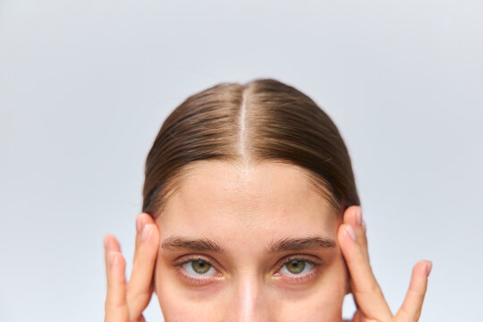 A woman massages her temples