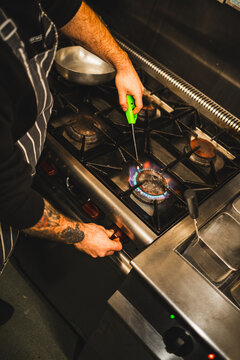 Chef lights stove burner
