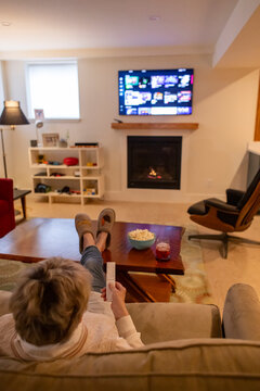 Senior citizen watch television at home alone