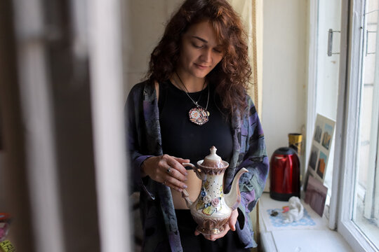 woman holding a coffee pot