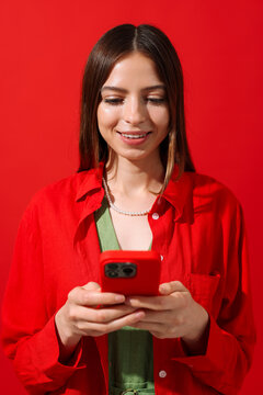 Happy Woman Looking at Mobile Screen in red 