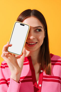 Woman Smiling Holding Phone Mockup with white screen 

