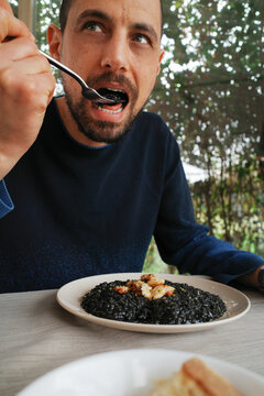 Eating cuttlefish ink risotto