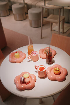 Colorful drinks and desserts on round white table