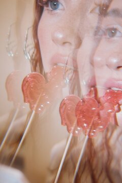 Dreamy portrait of woman with sweet lollipop