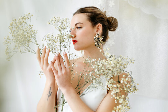 Beautiful bride holding gypsophila flowers 