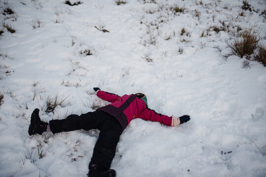 Girl making snow angels