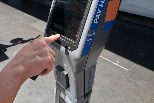 Locals use parking meter in city to pay for parking fees accurately