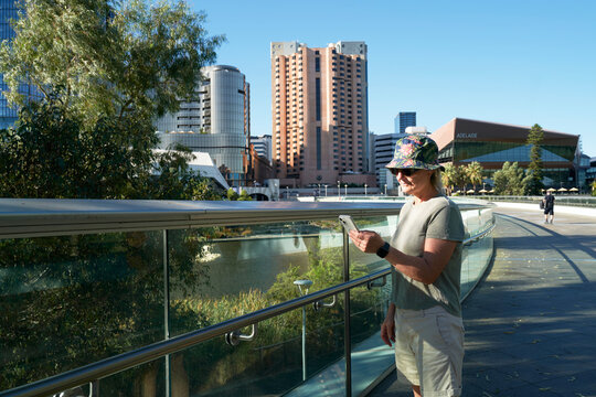 Tourist visiting Adelaide and using phone for map directions 