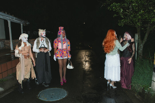Group of drag queens posing outdoors 
