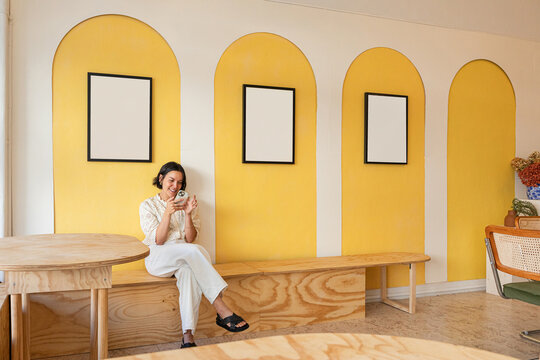 Casual woman enjoying her phone in cozy room