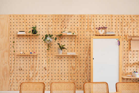 Stylish wall with greenery and modern decor with a white board