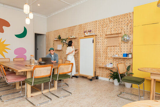 Two people interacting in a modern workspace