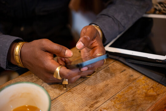 Black man working by a wooden desk