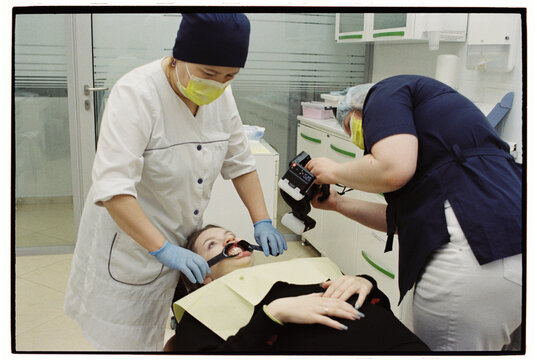 Dental Professionals Performing a Procedure in a Clinic
