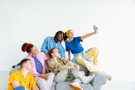 A group of young people taking selfies on camera