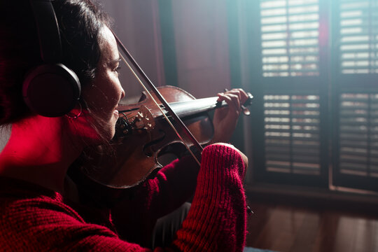 Smiling violinist playing at home