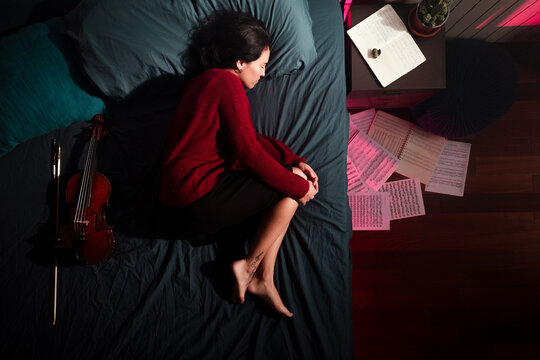 Happy woman dreaming on bed 