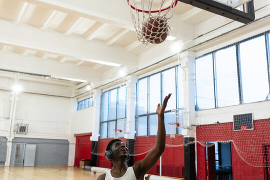 Basketball Player Shooting the Ball in Gym
