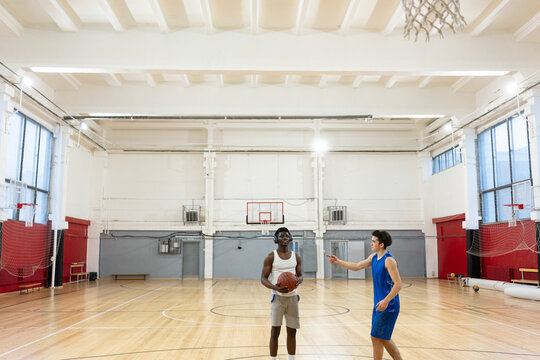Two young male basketball players engage in a one-on-one game