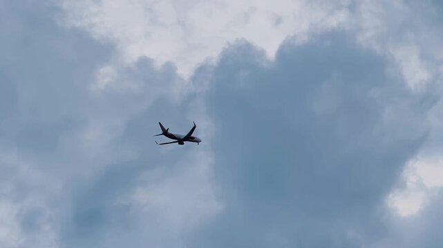 Jakarta, Indonesia - February 17, 2026 : A low-angle cinematic shot of a Batik Air Indonesia Airbus preparing to land at the airport in the afternoon clouds.