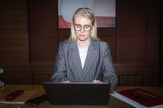 A woman uses a laptop in the office