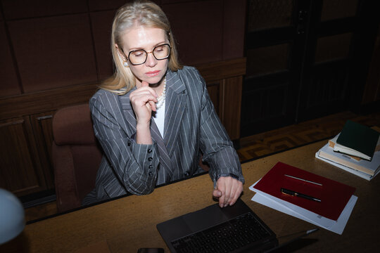 A woman uses a laptop in the office