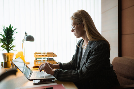 A woman uses a laptop in the office