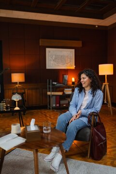 A woman is sitting in an armchair