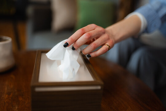 A woman's hand takes a napkin from a package
