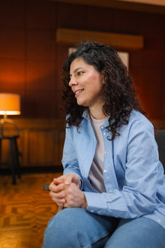 A woman is sitting in an armchair