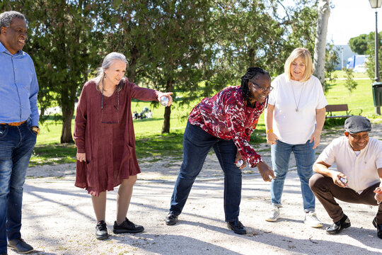 Diverse Group of Senior friends playing bocce in park
