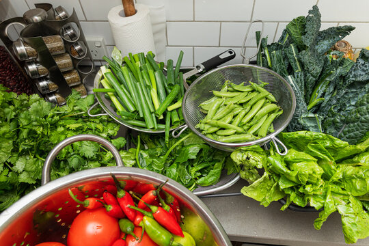 Colorful vegetables in colanders ready for cooking