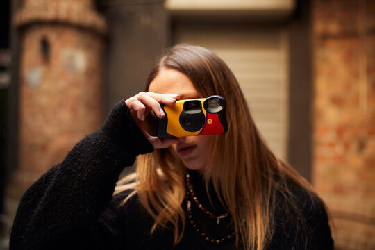 Portrait of a woman using a film camera