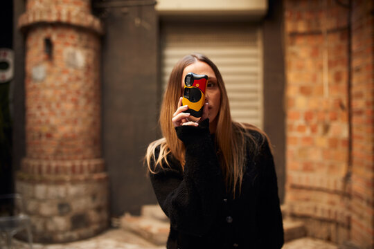 Woman using film camera