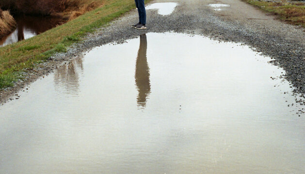 Silhouette's reflection in a puddle