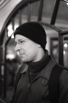 Profile portrait of a man with slight smile and a beanie