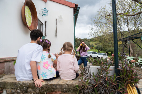 Woman taking photo of family