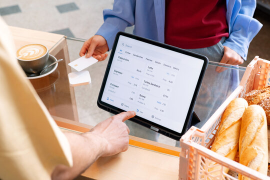 Woman to Pay Card on Square POS in Bakery Caf&eacute;