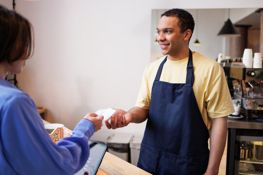 Smiling Barista Accepts Card Payment