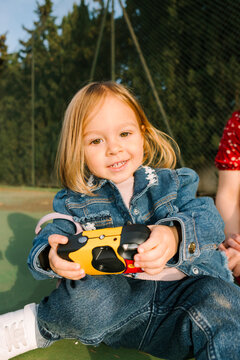 Smiling toddler with camera
