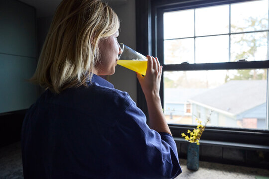 Woman drinking magnesium mix in the kitchen