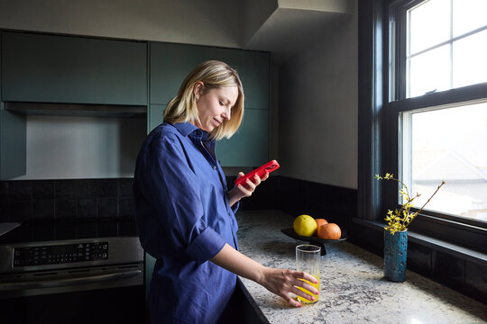 Woman drinking magnesium mix in the kitchen