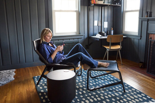 Young woman lounges in her chair at home 