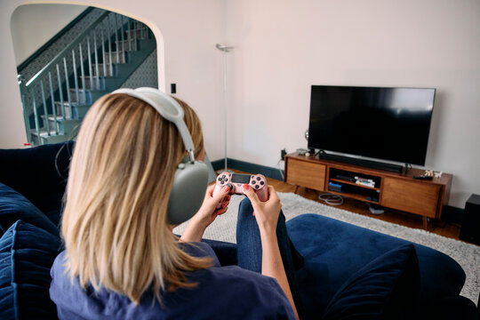 Woman playing video games on a controller