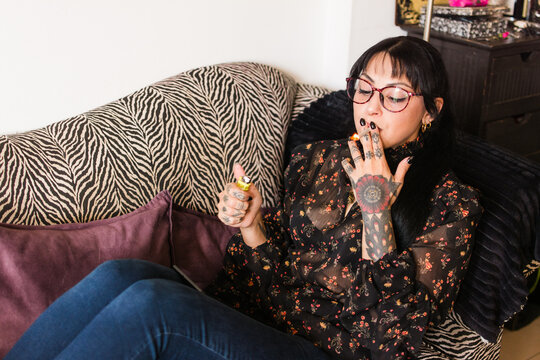 Woman relaxing at home with cannabis