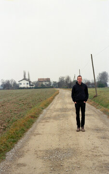 Man standing alone on an empty road track