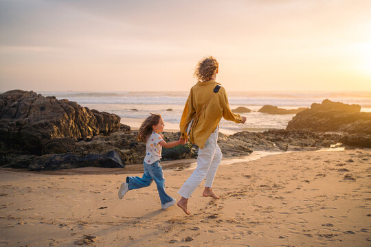 Running along shoreline at sunset