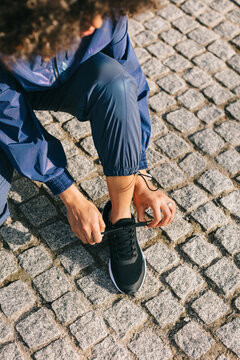 Hands tying running shoes